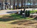 Street view of several lakeside homes surrounded by mature trees at 220 Kenway Loop, Mooresville, NC 28117