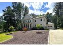 Beautiful gray home featuring an attached garage and a well-manicured lawn with decorative trees at 220 Kenway Loop, Mooresville, NC 28117