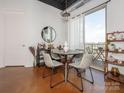 Bright dining area with modern table, stylish chairs, decor, and access to a balcony with city views at 2338 Yadkin Ave # 503, Charlotte, NC 28205