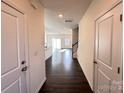 Inviting hallway featuring wood floors and leading to open living area at 2623 Aubrey St, Monroe, NC 28110