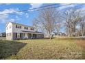 Traditional two-story home showcasing mature trees, a well-maintained lawn, and a classic American facade at 303 Bost St, Kannapolis, NC 28081