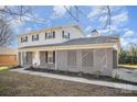 Exterior shot featuring the covered front porch, light gray brick accents and a well-manicured lawn at 303 Bost St, Kannapolis, NC 28081