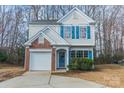 Charming two-story home featuring a brick accent garage and beautiful blue shutters at 3554 Laurenhurst Ln, Charlotte, NC 28270