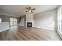 Spacious living room featuring a fireplace, ceiling fan, and bright windows at 3554 Laurenhurst Ln, Charlotte, NC 28270