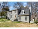 Charming two-story home with a beautiful gray exterior, landscaped yard and cozy wooden front door at 5019 Crooked Oak Ln, Charlotte, NC 28226