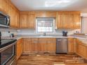 Well-lit kitchen featuring stainless steel appliances and ample oak cabinetry at 5789 Gettysburg Nw Dr, Concord, NC 28027