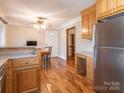 Bright kitchen and breakfast nook with wooden cabinets and stainless steel refrigerator at 5789 Gettysburg Nw Dr, Concord, NC 28027