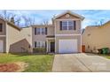 Charming two-story home with a one-car garage, well-manicured lawn, and complemented by a concrete driveway at 5830 Kelden Walker Ln, Charlotte, NC 28269