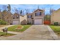 Inviting two-story home with neutral siding, black shutters, concrete driveway, and a well-kept lawn at 5830 Kelden Walker Ln, Charlotte, NC 28269