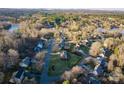 Aerial shot showcasing a neighborhood setting with tree-lined streets and beautiful homes at 6068 Gold Creek Estate Dr, Hickory, NC 28601