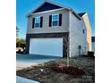 Two story home with a two car garage, combination siding and brick exterior and newly installed landscaping at 812 N Naughton St, Chester, SC 29706