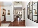 Elegant foyer featuring hardwood floors, high ceilings, and a view of the living spaces at 8412 Westmoreland Lake Dr, Cornelius, NC 28031