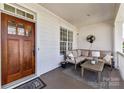 Comfortable front porch with ample seating and a ceiling fan at 8412 Westmoreland Lake Dr, Cornelius, NC 28031