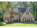 Traditional brick home with manicured lawn and mature landscaping at 9022 Taunton Dr, Huntersville, NC 28078