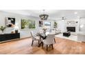 Open concept dining area with modern chandelier and views into the living room at 908 Coventry Rd, Kannapolis, NC 28081