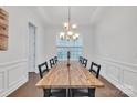 Dining room with hardwood floors, and a wooden table with black chairs under chandelier at 944 Treasure Ct, Fort Mill, SC 29708