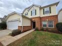 Charming two-story home with a two-car garage, brick accents, and a well-maintained front lawn at 10927 Kinnairds St, Charlotte, NC 28278