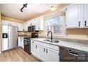 Bright kitchen features granite countertops, stainless steel appliances, and white cabinetry at 1228 Hidden Creek Cir, Hickory, NC 28602