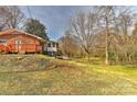 A lovely backyard offering space and privacy, enhanced by mature trees and a small deck at 1235 Robinhood Cir, Charlotte, NC 28227