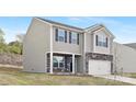 Charming two-story home featuring stone accents, gray siding, and a well-maintained lawn at 124 Rustling Waters Dr, Mooresville, NC 28117