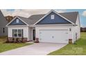 Charming single Gathering home showcasing a 2-car garage, stone accents, and manicured lawn at 146 Jacobs Hill Pl, Troutman, NC 28166