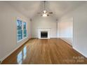 Open living room features vaulted ceilings, a fireplace, and beautiful hardwood floors at 1971 Bristol Pkwy, Rock Hill, SC 29732