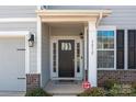 Inviting front door with sidelights and transom window, plus brick accents at 3212 Burnello Ct, Iron Station, NC 28080