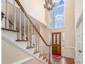 Bright foyer featuring a staircase, hardwood floors, and a large arched window above the front door at 3400 Thistle Bloom Ct, Charlotte, NC 28269