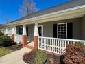 Inviting front porch with brick accents and white railings, perfect for relaxing outdoors at 4232 Cornelia Ln, Rock Hill, SC 29732