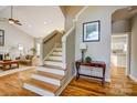 Inviting entryway featuring hardwood floors, stairs, and a view of the living room at 7306 Timbercreek Ct, Denver, NC 28037