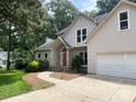 Exterior view of a two-story home with a brick facade, attached garage, and a well-maintained lawn at 7306 Timbercreek Ct, Denver, NC 28037