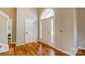 Bright foyer showcasing hardwood floors and a large arched window above the front door at 7306 Timbercreek Ct, Denver, NC 28037