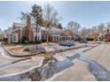 View of townhomes and parking area with puddles reflecting the buildings at 9128 Kings Canyon Dr, Charlotte, NC 28210