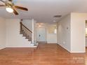Spacious living room with wood floors and stairs to the second level at 9128 Kings Canyon Dr, Charlotte, NC 28210