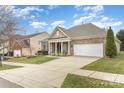 Charming brick house with a manicured lawn, covered porch, and long driveway in a Gathering-friendly neighborhood at 9795 Shearwater Nw Ave, Concord, NC 28027