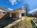 Attached carport with a spacious driveway and access to the backyard at 105 Brickyard Rd, Fort Mill, SC 29715