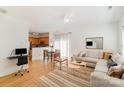 Open-concept living area featuring a comfortable sofa, dining space, and kitchen in a naturally lit interior at 10530 Stoneacre Ct, Pineville, NC 28134
