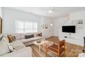 Bright living room with a cozy sectional sofa, wood floors, and modern decor creating a welcoming atmosphere at 10530 Stoneacre Ct, Pineville, NC 28134