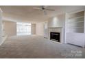 Spacious living room featuring a fireplace, built-in shelving and neutral tones at 11 Heritage Ln, Shelby, NC 28150