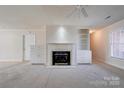 Cozy living room with a fireplace, built-in cabinets and carpet flooring at 11 Heritage Ln, Shelby, NC 28150