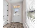 Bright entryway featuring decorative tile flooring, natural light from the door window, and a white door at 1114 Roderick Dr, Fort Mill, SC 29708