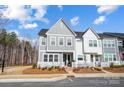 Inviting two-story townhome with neutral siding, a welcoming entrance, and manicured landscaping at 118 Isleworth Ave, Mooresville, NC 28117