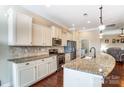 Bright kitchen with granite counters, stainless appliances, and ample white cabinetry at 120 Sycamore Dr, Lancaster, SC 29720