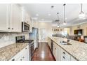 Open kitchen with granite counters, stainless appliances, and hardwood flooring at 120 Sycamore Dr, Lancaster, SC 29720