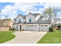 Lovely home with a three-car garage and concrete driveway on a lush green lawn at 122 Round Rock Rd, Troutman, NC 28166