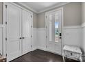The foyer features dark wood flooring and elegant white wainscoting at 122 Round Rock Rd, Troutman, NC 28166