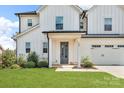 Charming home featuring an inviting covered front porch and a spacious three-car garage at 122 Round Rock Rd, Troutman, NC 28166