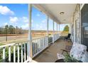 Expansive front porch showcasing the view and featuring comfortable seating areas with decorative touches at 1249 Maddy Ln, Rock Hill, SC 29732