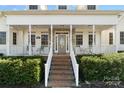 Inviting front porch with stone accents, a decorative front door, and a well-maintained landscape at 1249 Maddy Ln, Rock Hill, SC 29732