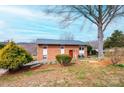 Lovely brick home featuring well-manicured front yard with mature trees and an inviting entrance at 1285 Riverview Dr, Hickory, NC 28602